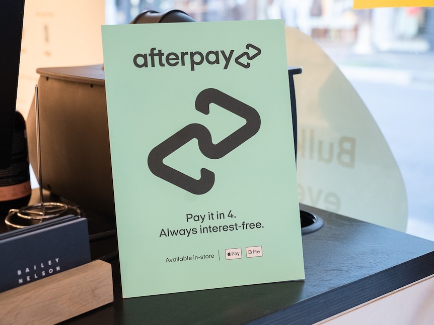Sign with Afterpay logo sitting on a counter