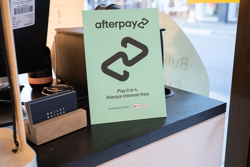 Sign with Afterpay logo sitting on a counter