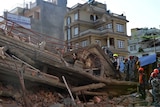 Rescue team officials search for survivors at a collapsed building in Kathmandu