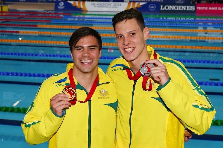 Australia's Ben Treffers (L) and Mitch Larkin (R) pose with their gold and silver medals after the 50m backstroke in Glasgow