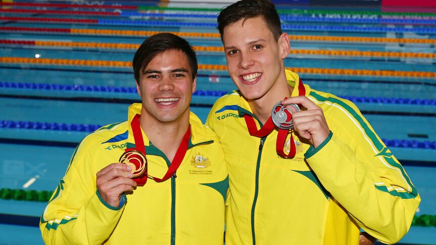 Australia's Ben Treffers (L) and Mitch Larkin (R) pose with their gold and silver medals after the 50m backstroke in Glasgow