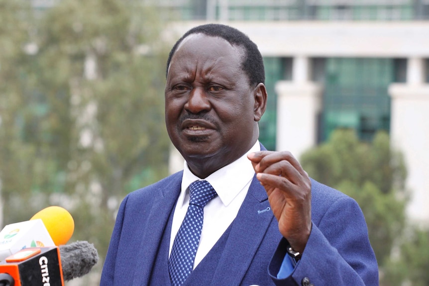 Kenyan presidential candidate Raila Odinga in a suit addresses the media with a serious face