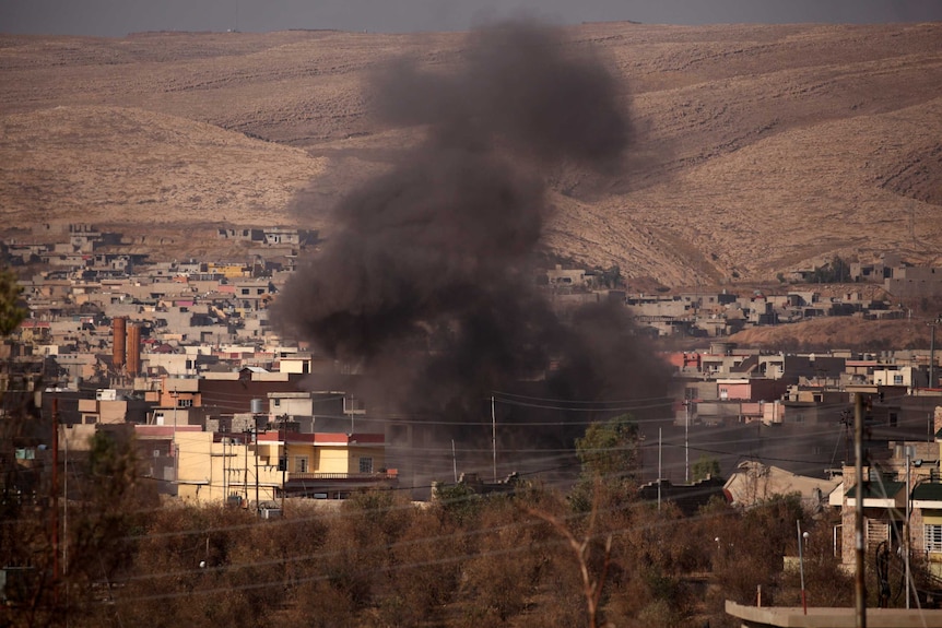 Smoke rises during clashes between Peshmerga forces and Islamic State militants in the town of Bashiqa, Iraq.