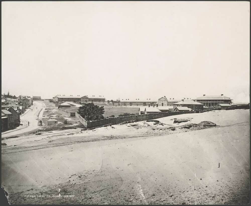 An old sepia photo of a barracks on a large block of land, with a small left hand side scribble saying 1871.