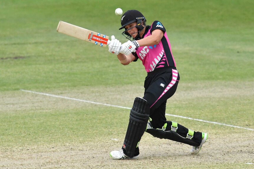 A New Zealand batter lofts the ball through mid-wicket to the boundary to win a T20 international.