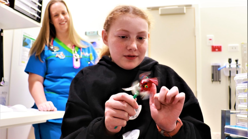 Toni Grayson plays with a sensory toy at the hospital.