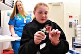 Toni Grayson plays with a sensory toy at the hospital.