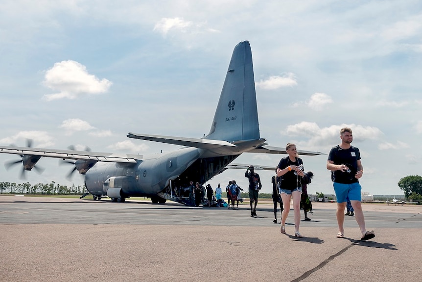 Residents walk across the tarmac