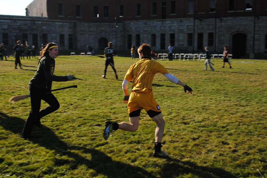 A seeker chases the golden snitch in real-life quidditch, inspired by the Harry Potter series.