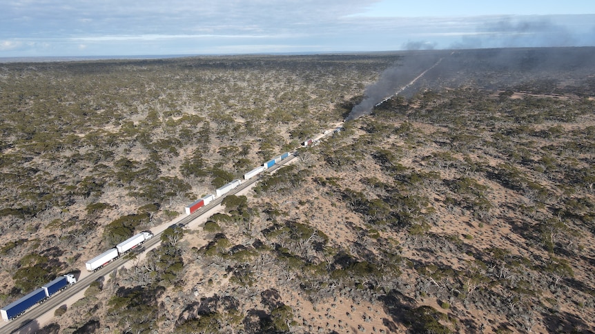 Smokes rises from a truck crash site.