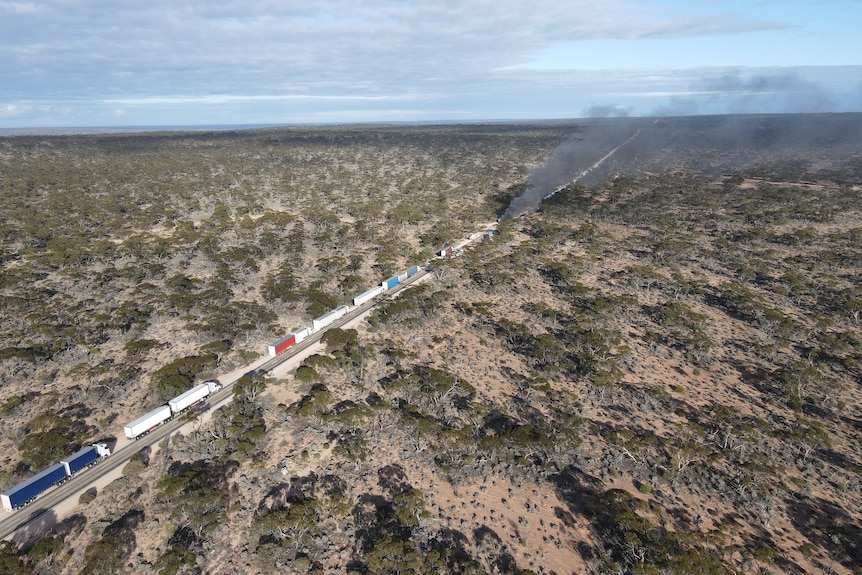 Smokes rises from a truck crash site.