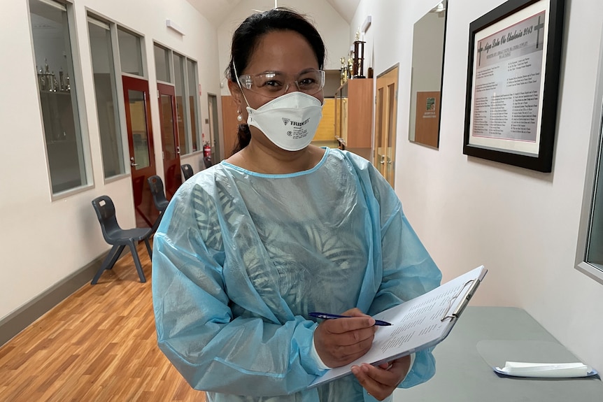 Dr Sherry Tagaloa wearing PPE and holding a clipboard.
