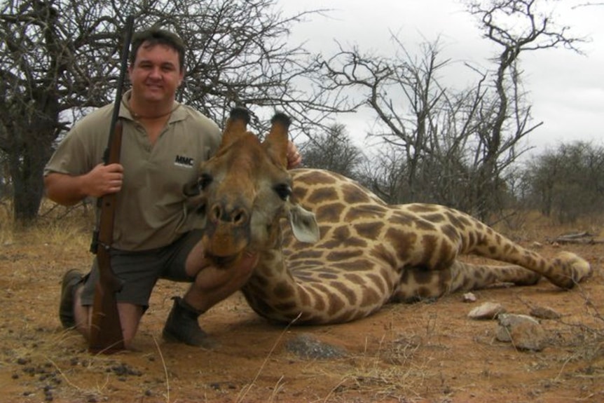 A picture of Jewell Crossberg with a dead giraffe