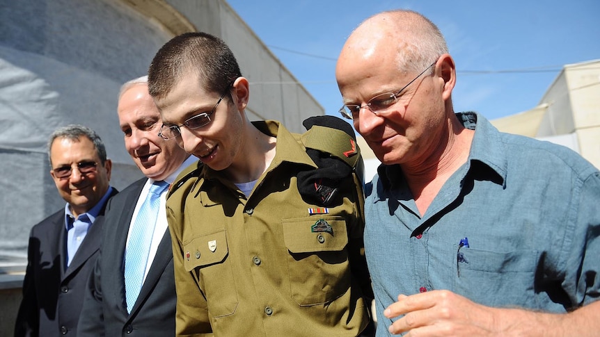 Freed Israeli soldier Gilad Shalit walks with his father, Ehud Barak and Benjamin Netanyahu (Getty Images/Israeli Defence Force)