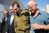 Freed Israeli soldier Gilad Shalit walks with his father Naom Shalit