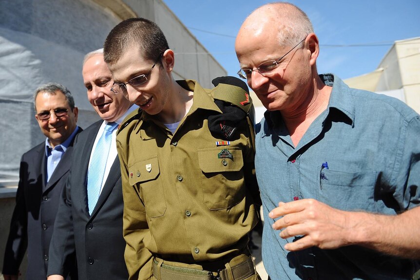 Freed Israeli soldier Gilad Shalit walks with his father Naom Shalit