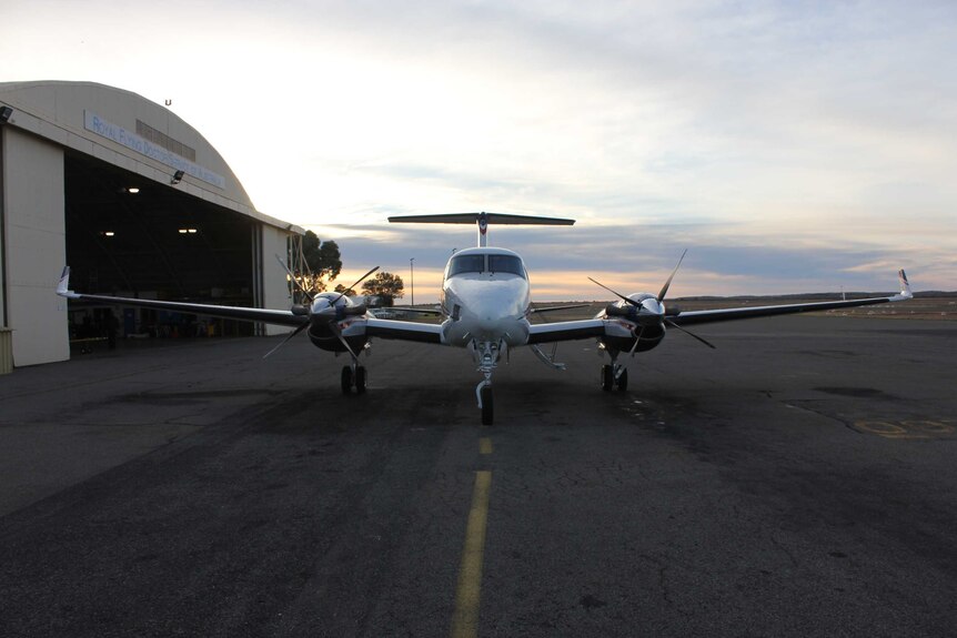 A Royal Flying Doctor Service plane waits on the tarmac outside the Broken Hill RFDS base.