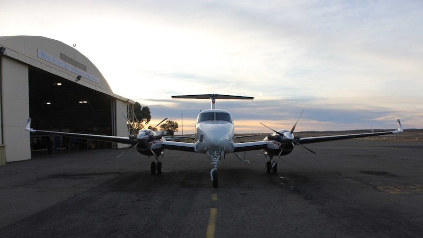 A Royal Flying Doctor Service plane waits on the tarmac outside the Broken Hill RFDS base.