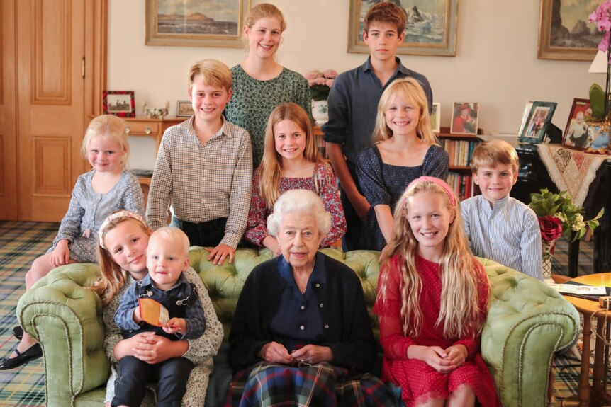 Queen Elizabeth sits in the middle of her grandchildren and great-grandchildren