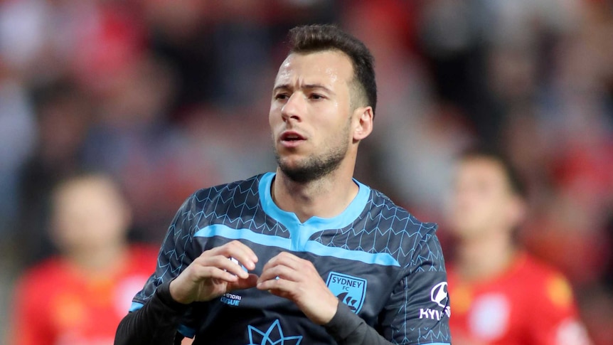 Sydney FC striker Adam Le Fondre makes a heart symbol with his hands.