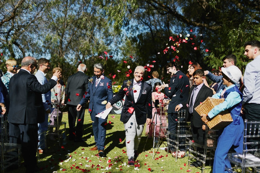 Evelyn and Sandra Gugliotta walk down the aisle