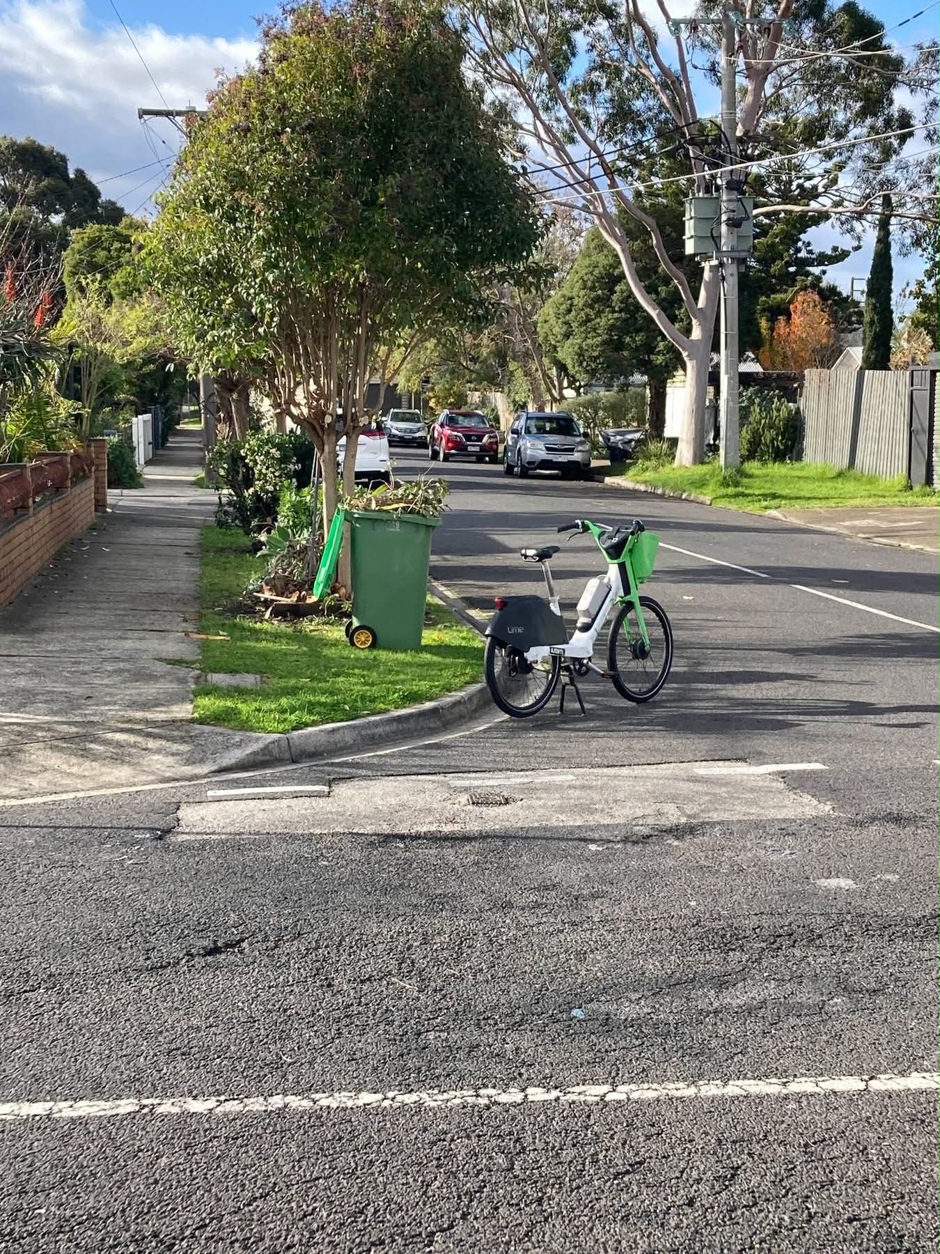 A lime e-bike on a road