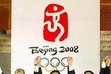 Olympic officials raise their arms after unveiling the official emblem for the 2008 Beijing Games.