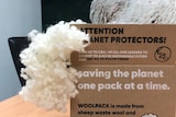 A cardboard box with wool packaging emerging from it.