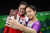 Lee Eun-ju of South Korea (R) takes a selfie with Hong Un-jong of North Korea