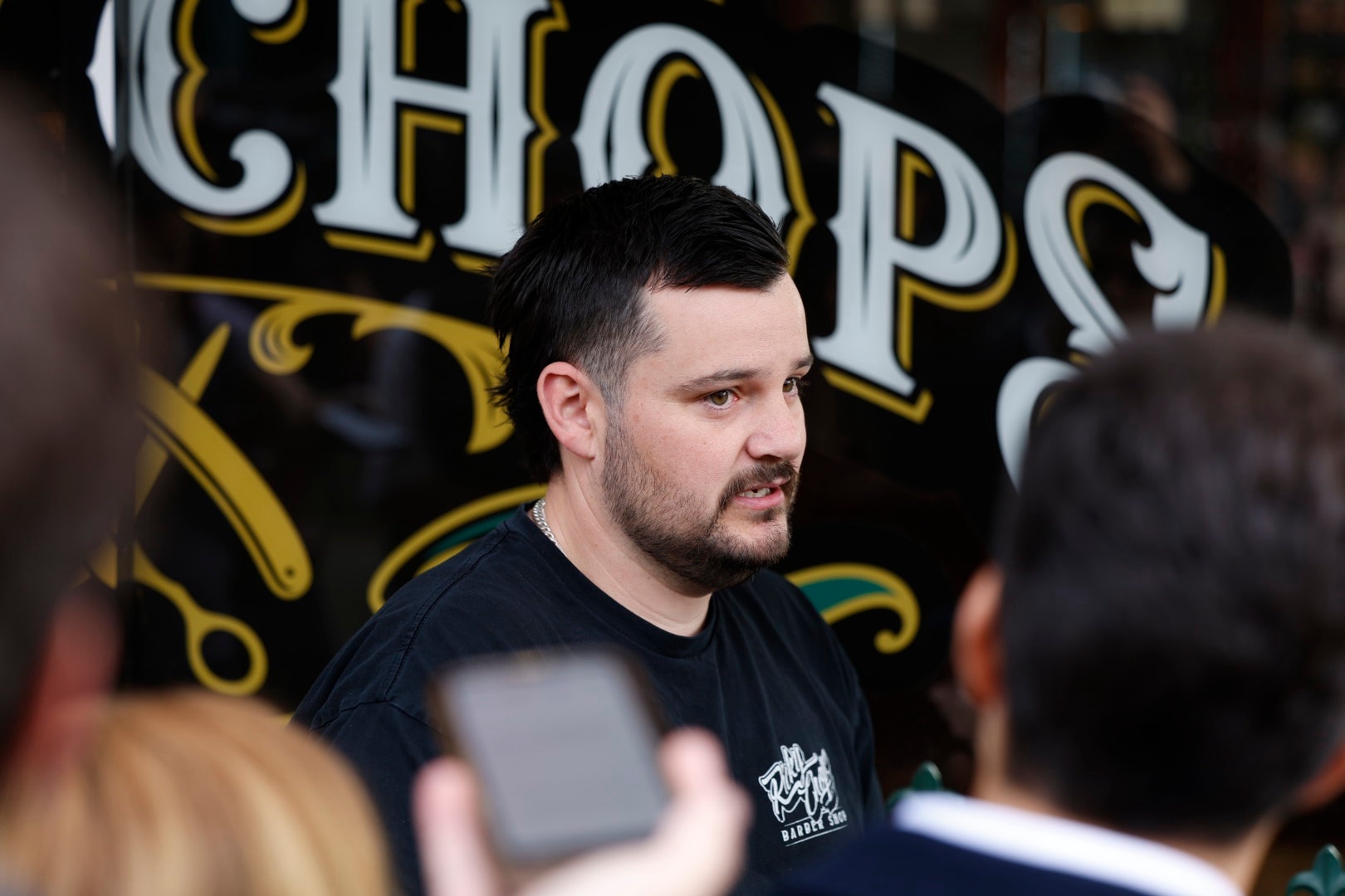 Barber denies heroism over Haines attack, hails person who sat in front of car