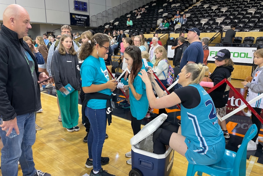 Lauren Jackson signs a fans shirt