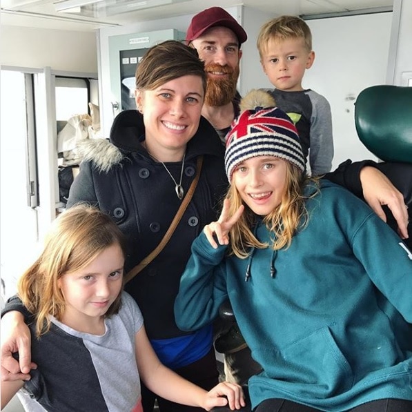 Sam Jockel poses for a photo with her husband and three children.