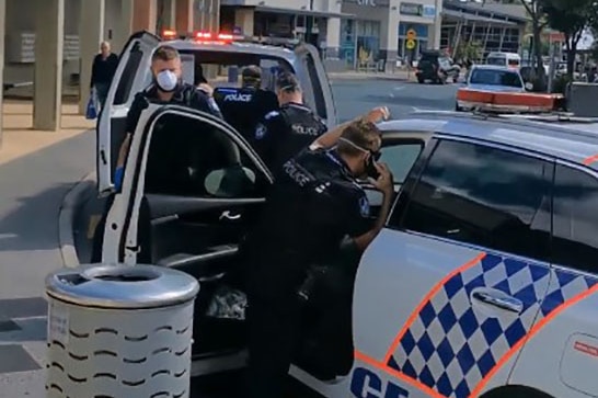 Queensland police officers in face masks and vehicles outside Noosa Civic Shopping Centre on August 10, 2020.