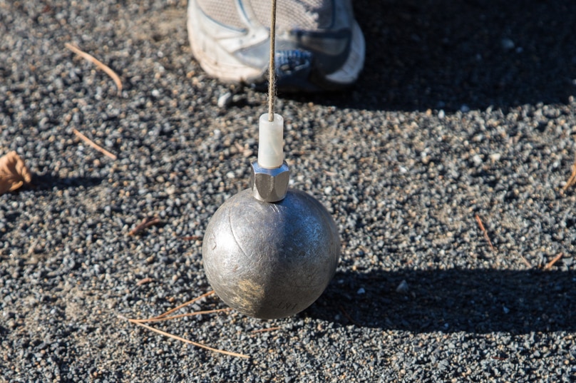 Petanque boules are picked up with a magnetic bolt on string.
