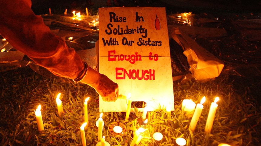 A participant lights a candle