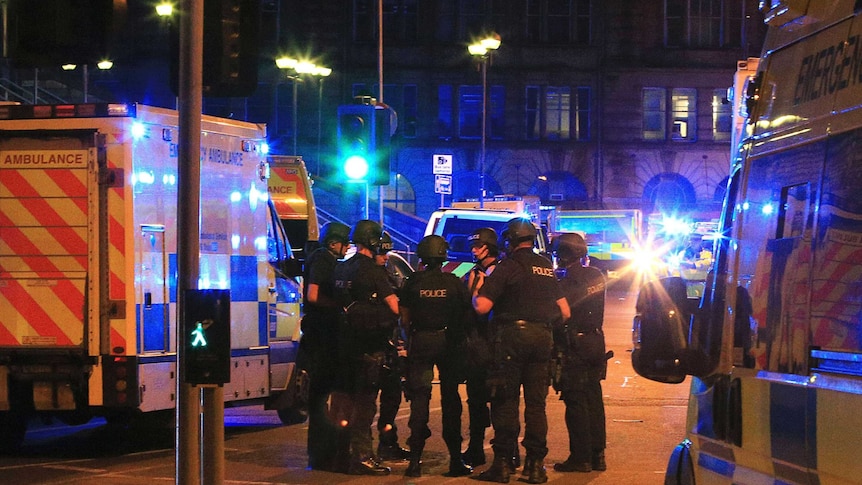 Armed police gather at Manchester Arena after reports of an explosion at the venue