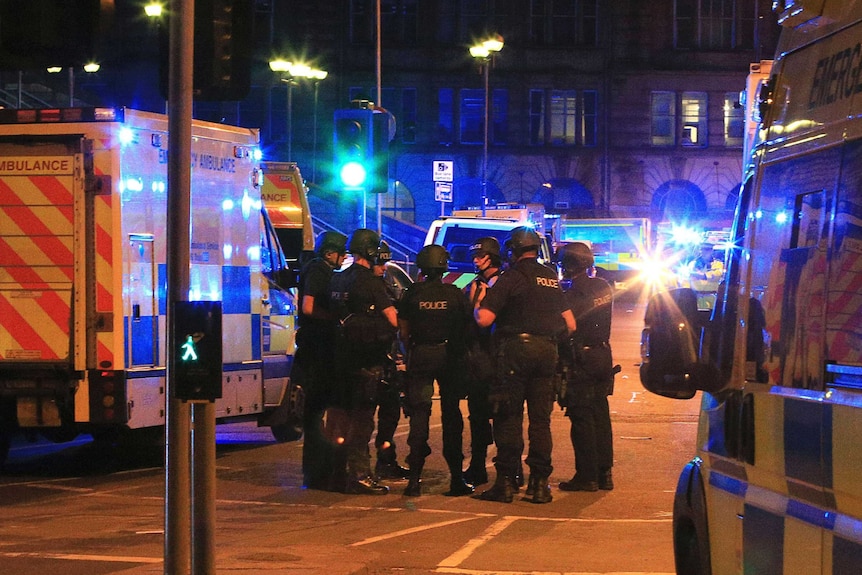 Armed police gather at Manchester Arena after reports of an explosion at the venue