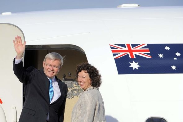 Kevin Rudd and wife Therese Rein wave to the media from the steps of their plane