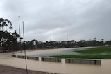 Wide shot of Gnowangerup football oval inundated with water after heavy rain.