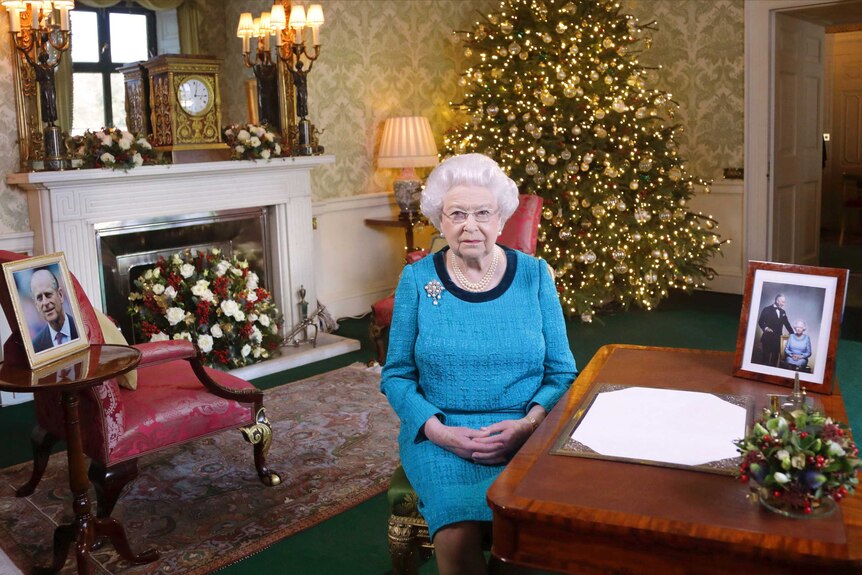 Britain's Queen Elizabeth II poses for a photo, sitting at a desk in the Regency Room of Buckingham Palace
