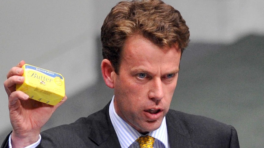 Dan Tehan holds up a stick of butter in federal parliament