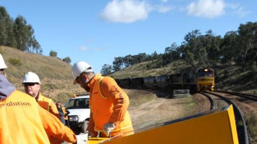 A Greenpeace protestor inside a steel box on rail tracks in the Hunter Valley.