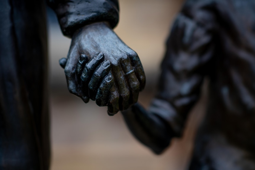 Close up of a statue of hands holding