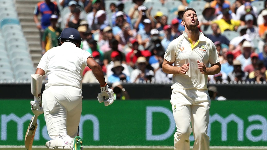 Australian bowler Mitchell Marsh moans with his eyes closed as Indian batsman Cheteshwar Pujara sets off for a run.