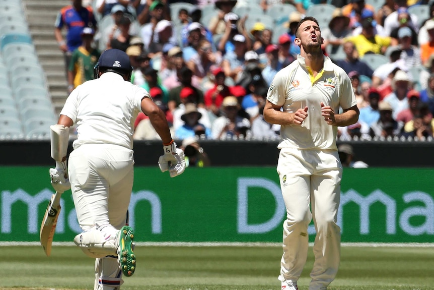 Australian bowler Mitchell Marsh moans with his eyes closed as Indian batsman Cheteshwar Pujara sets off for a run.