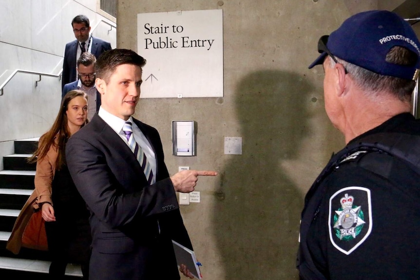 Staffers walk down stairs into Parliament House