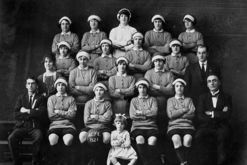 A black and white photo of a women's football team