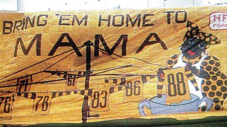 A Hawthorn banner that reads 'Bring 'em home to Mama' and depicts a caricature of a black woman