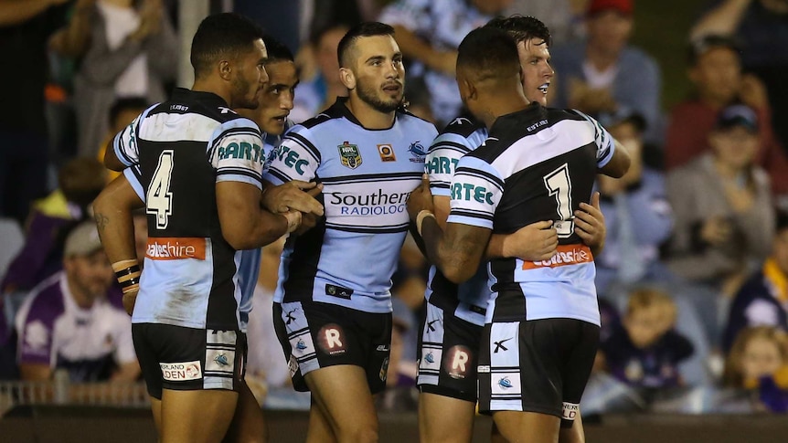 Cronulla players celebrate try by Chad Townsend against Melbourne at Shark Park on March 28, 2016.