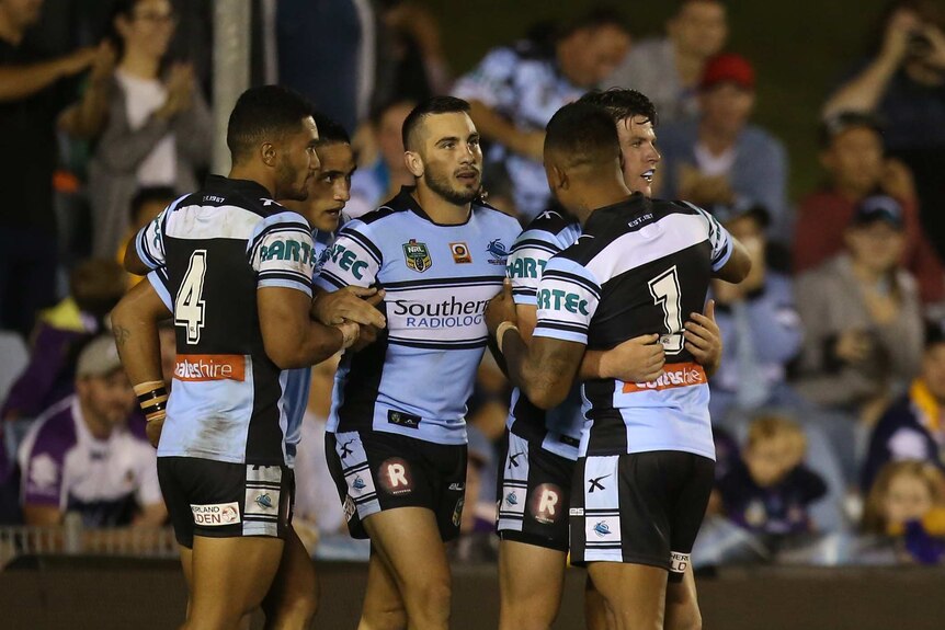 Cronulla players celebrate Chad Townsend's try against Melbourne Storm